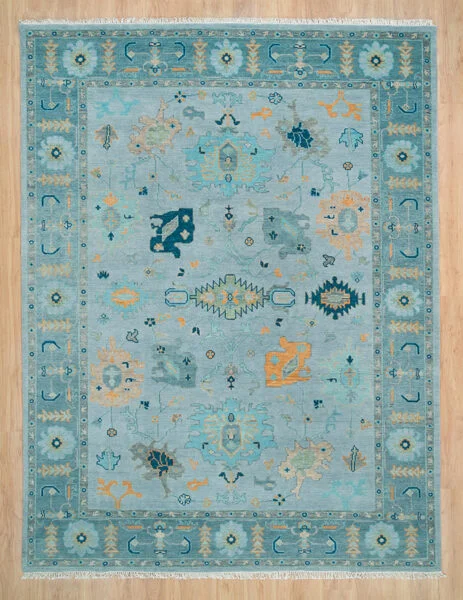 Hand-knotted wool oushak rug with a soft aqua field, wide teal border, and tonal palmette, vine, serrated-leaf, and cypress motifs in teal and gold with subtle figure-ground contrast.