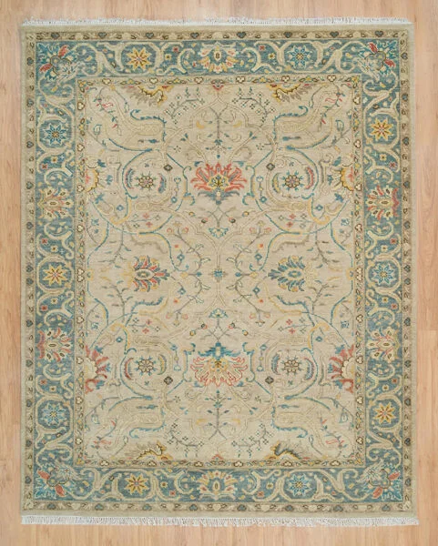 Hand-knotted wool oushak rug with a warm beige field, wide teal border, and dense tonal vine, palmette, scroll, and lotus motifs in beige and ivory with a subtle, traditional character.