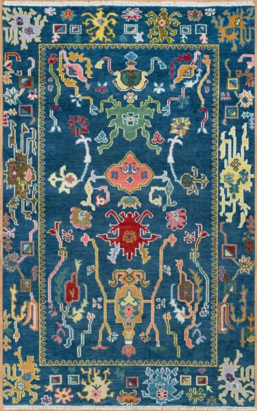 Hand-knotted wool oushak rug with a deep navy field, narrow gold-line border, and densely packed vivid palmettes, rosettes, scrolls, and a central medallion in green, red, gold, and coral.