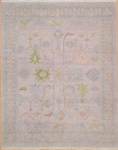 Hand-knotted wool oushak rug with a soft mauve-lavender field, wide grey-blue border, and airy pale green, blue, and blush palmettes, rosettes, and diamonds with generous open ground.