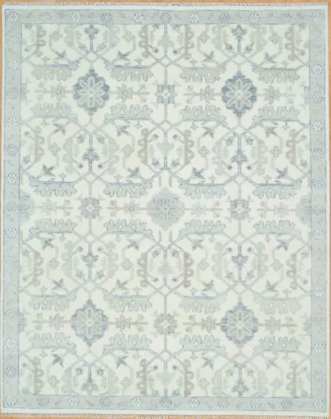 Hand-knotted wool Oushak rug with an ivory field featuring tonal grey palmettes and rosettes in a dense allover lattice pattern, with a narrow pale border.