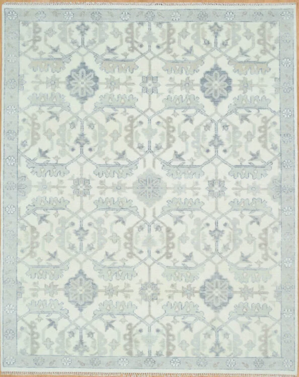 Hand-knotted wool Oushak rug with an ivory field featuring tonal grey palmettes and rosettes in a dense allover lattice pattern, with a narrow pale border.