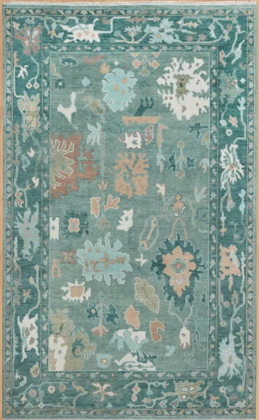 Hand-knotted wool Oushak rug with a muted teal field featuring oversized palmettes and serrated leaves in sage, ivory, and coral, framed by a wide deeper teal border.