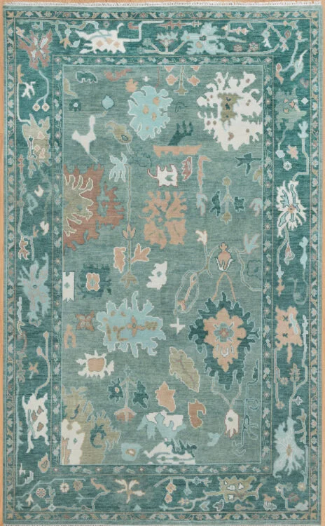 Hand-knotted wool Oushak rug with a muted teal field featuring oversized palmettes and serrated leaves in sage, ivory, and coral, framed by a wide deeper teal border.