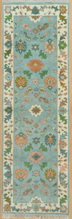 Hand-knotted modern Oushak wool runner rug with an aqua field, coral rosettes and green leaf motifs, and an ivory floral border.