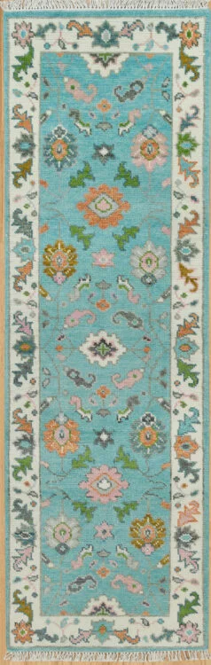 Hand-knotted modern Oushak wool runner with an aqua field, coral rosettes and green leaf motifs, and an ivory floral border.