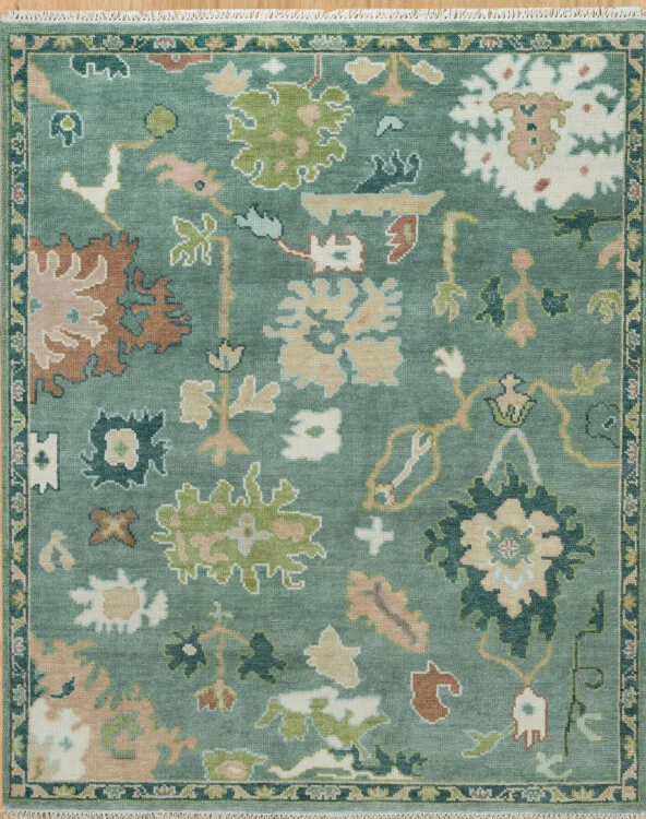 Hand-knotted modern Oushak wool rug with a sage green field, large green and ivory palmettes with rust and blush accents, and a thin dark border.