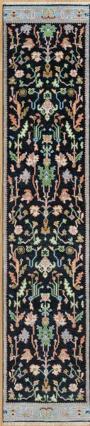 Hand-knotted wool oushak runner with a deep navy field, narrow blue border, and dense medium-scale palmettes, vines, and rosettes in coral, green, blush, and blue.