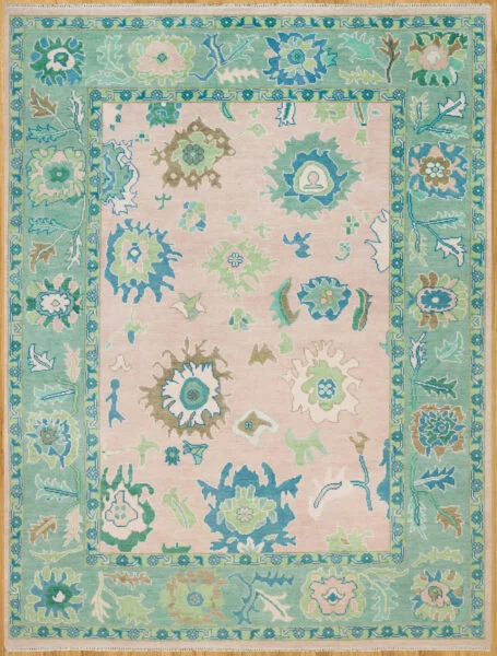Hand-knotted wool oushak rug with a soft blush field, wide teal border, and open large-scale palmettes and rosettes in teal, green, blue, and brown.