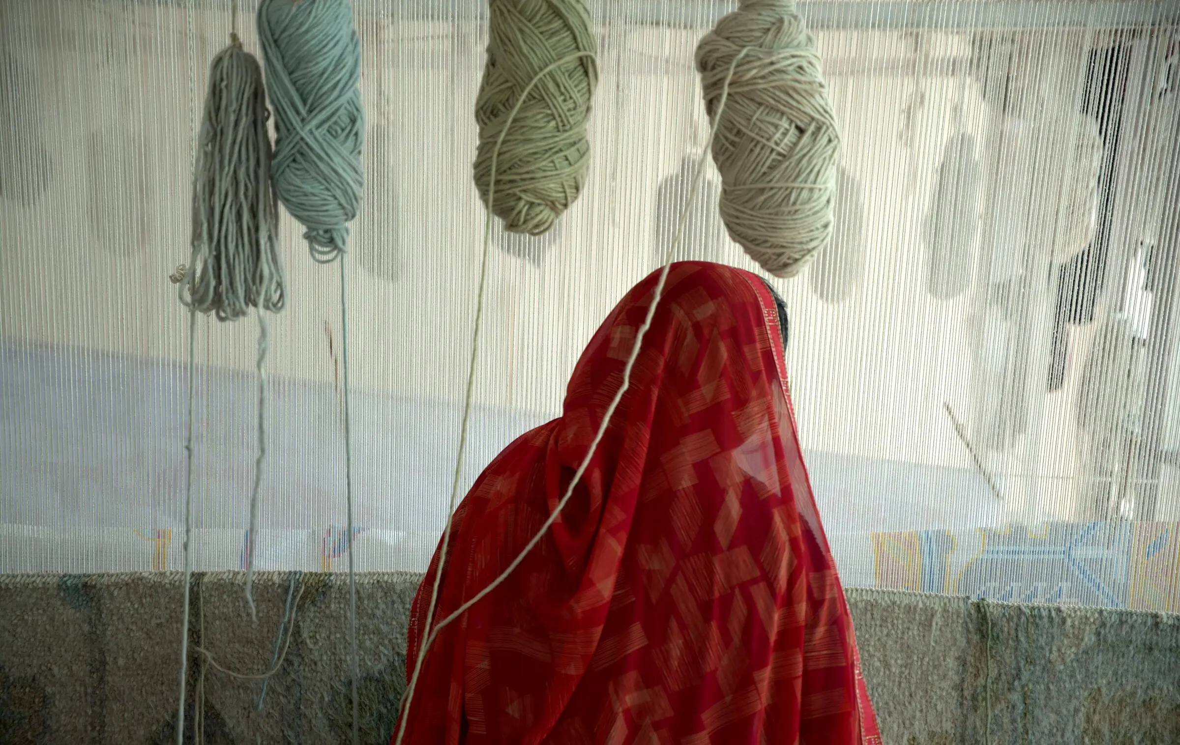 hand-knotted rug weaving on the loom in bhadohi